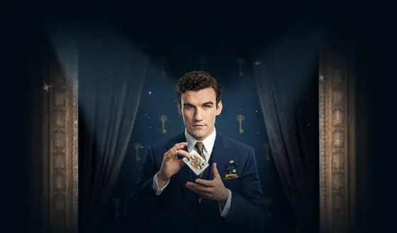 Elitespin high roller in a navy suit with a card